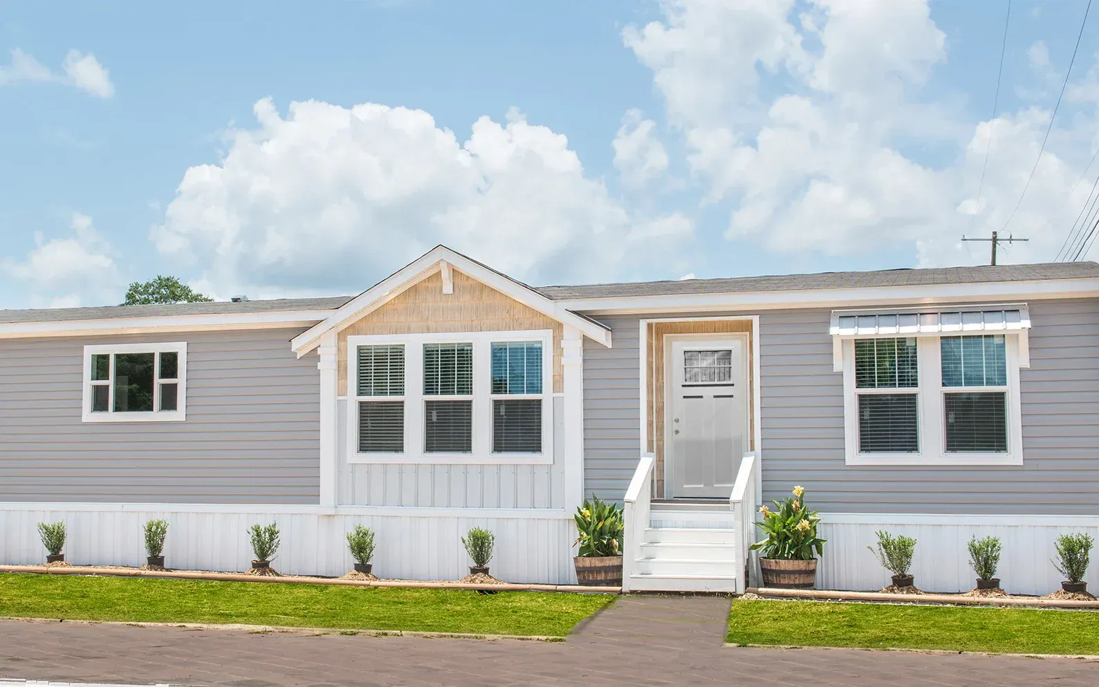 The front of a mobile home with a lot of windows and stairs.