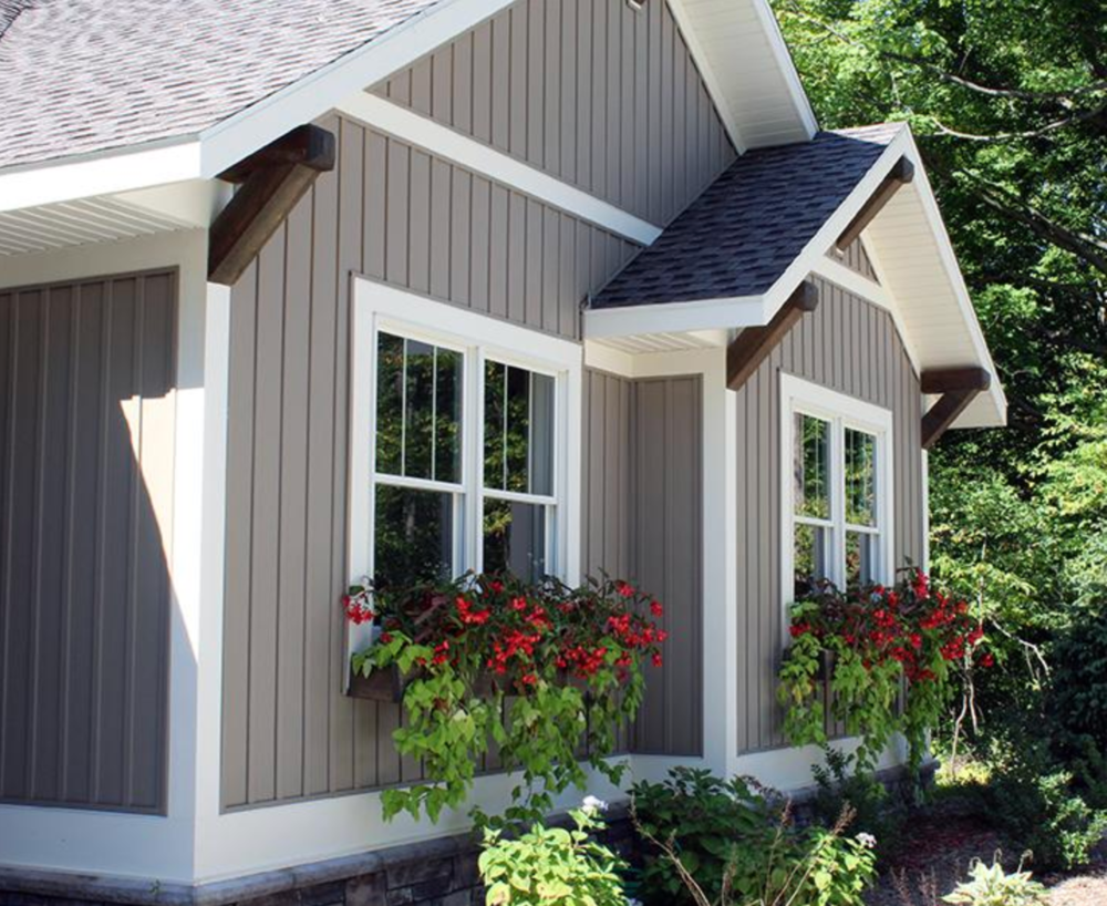 A house with a garage and a brick wall