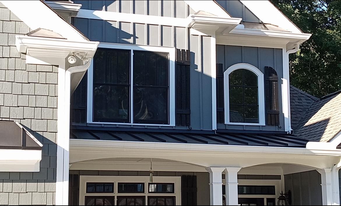 A house with a gray roof and white trim