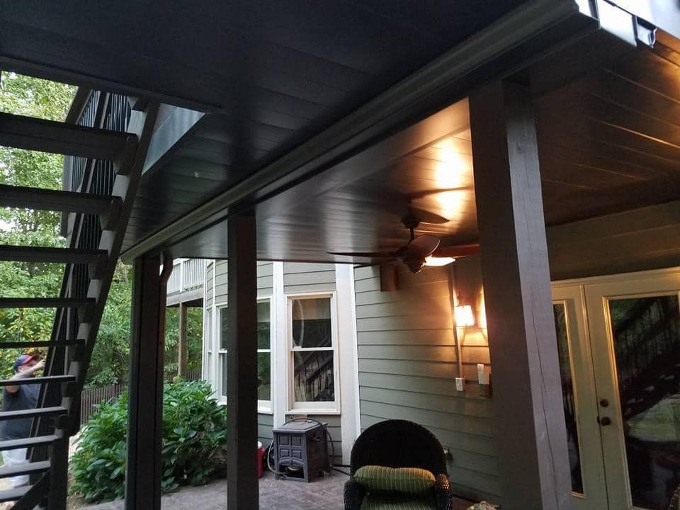 A porch with stairs and a ceiling fan