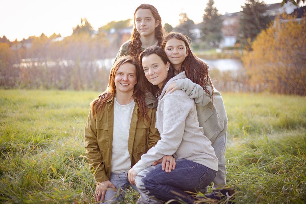 A group of women are posing for a picture in a field.