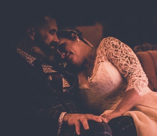 A man and a woman are sitting next to each other on a couch.