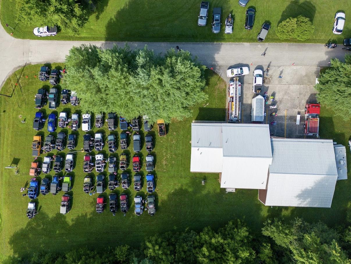 An aerial view of a parking lot filled with cars and trucks.