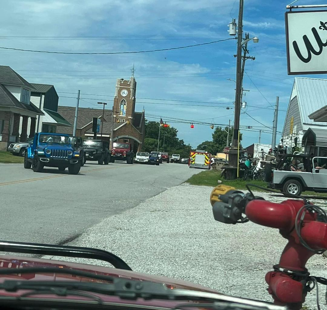 A red fire hydrant is on the side of the road