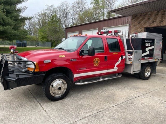 A red fire truck is parked in front of a garage.