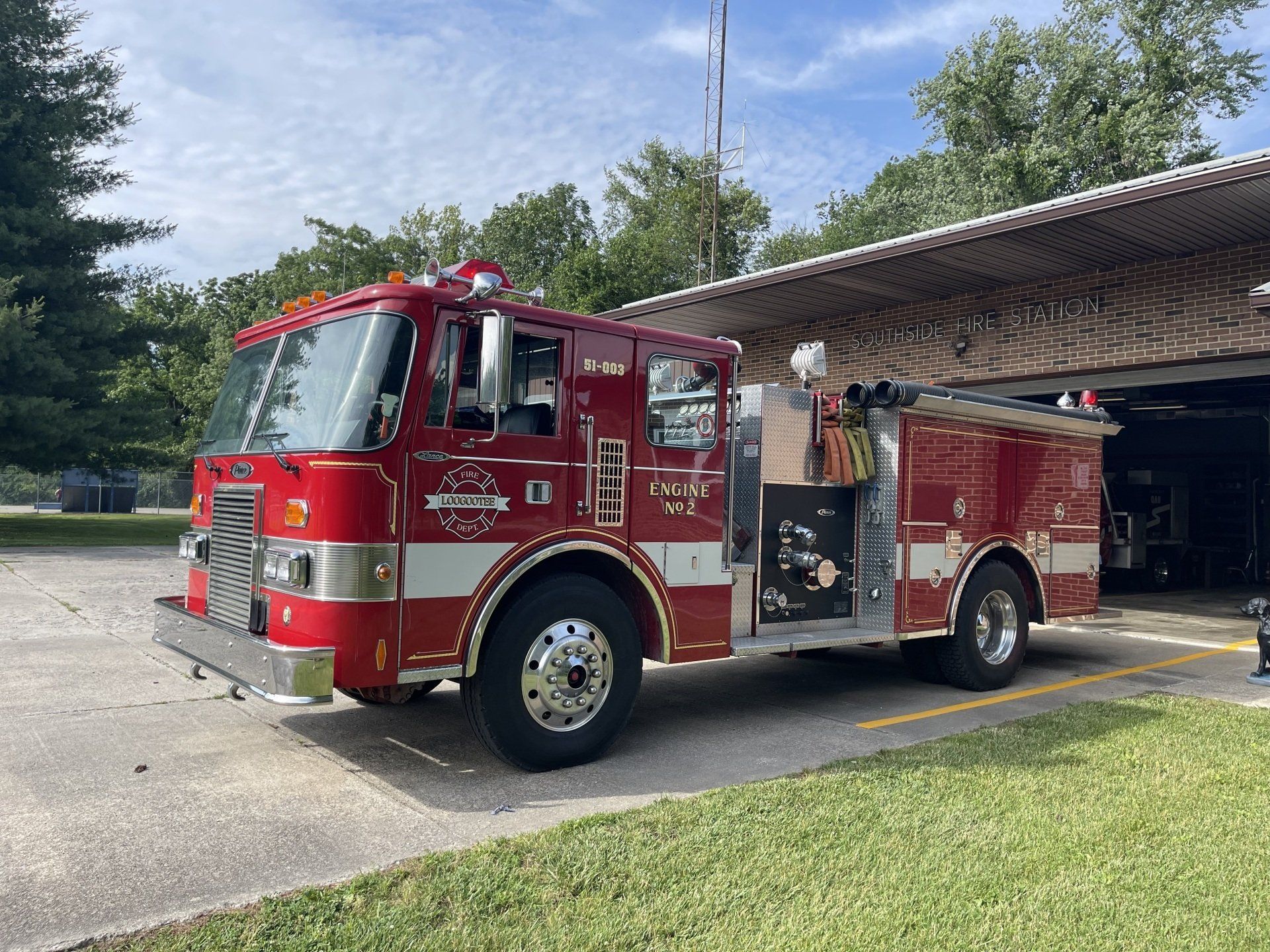 A red fire truck is parked in front of a building.