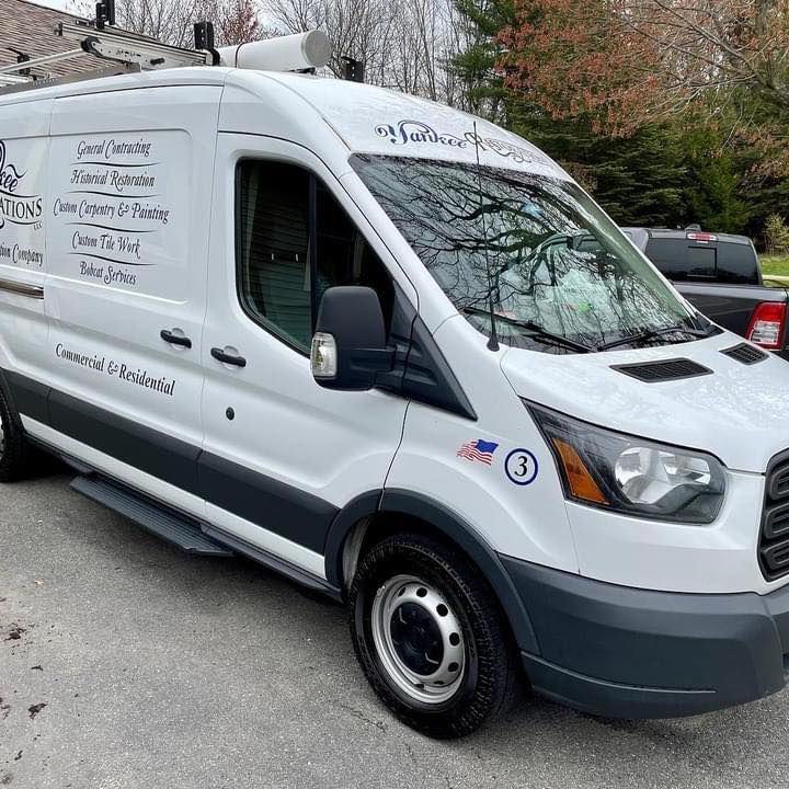 A white van is parked in front of a house.