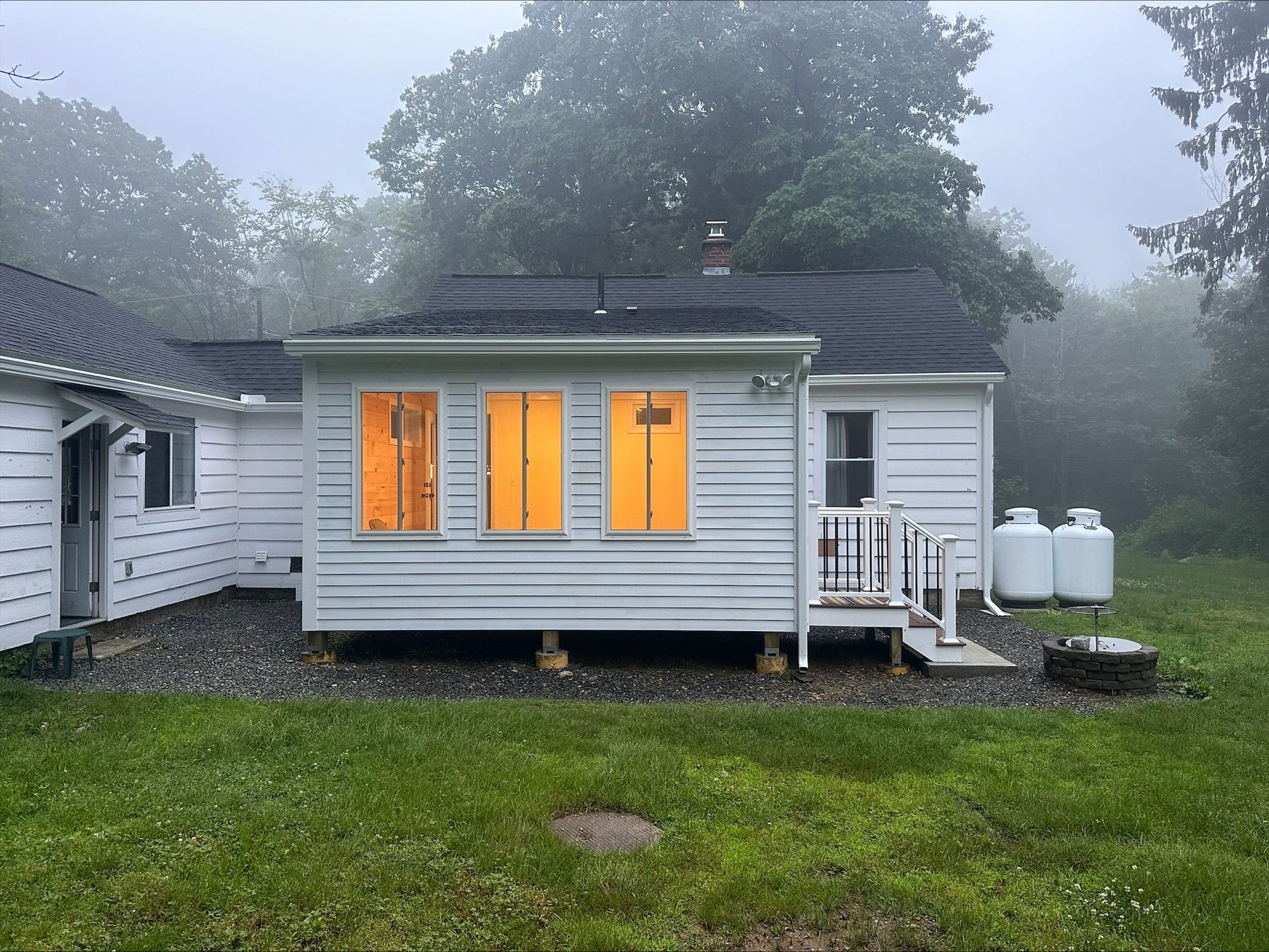 A wooden ramp leads to a deck between two mobile homes