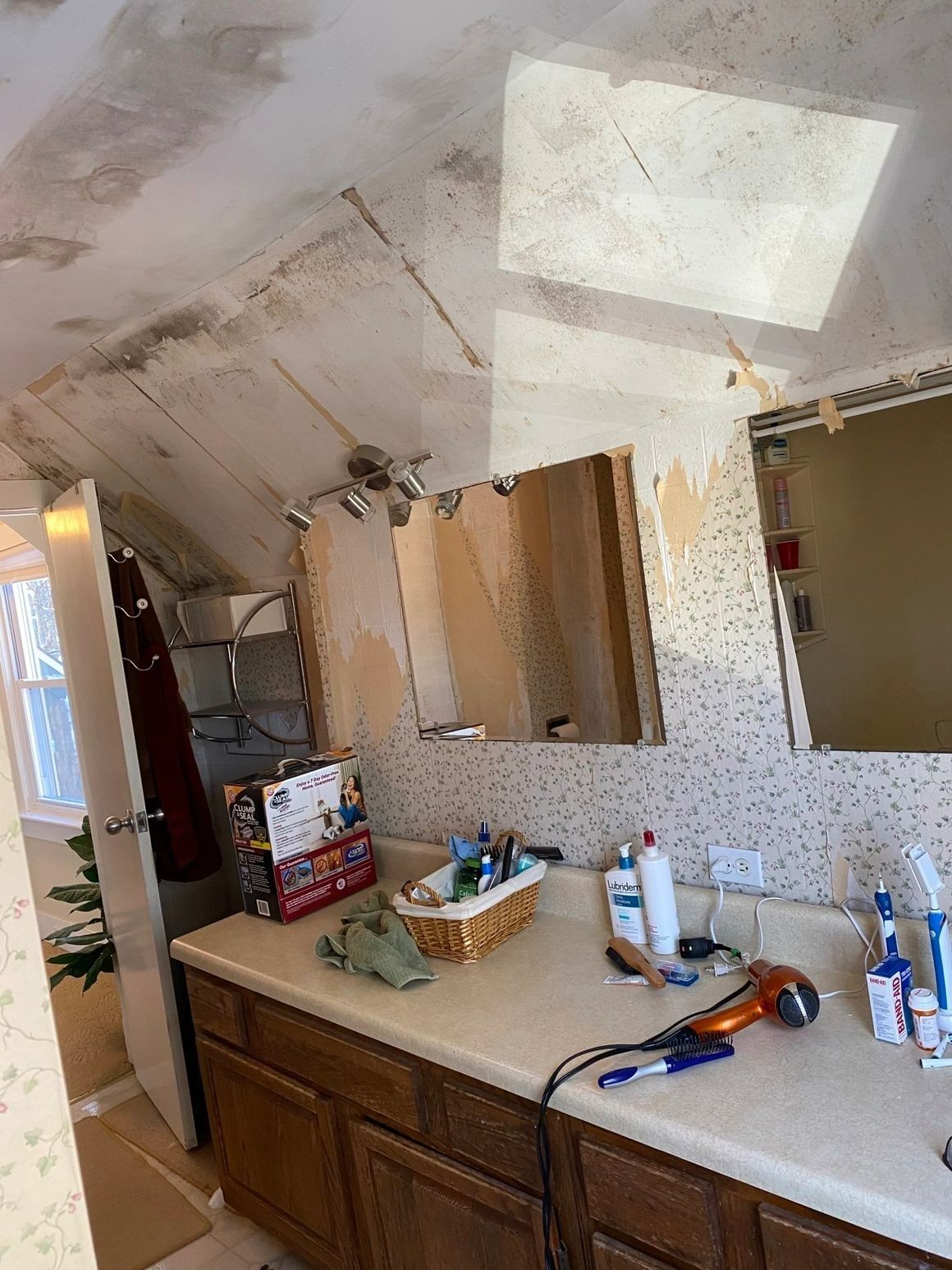 A bathroom with a sink , mirror , and cabinets.