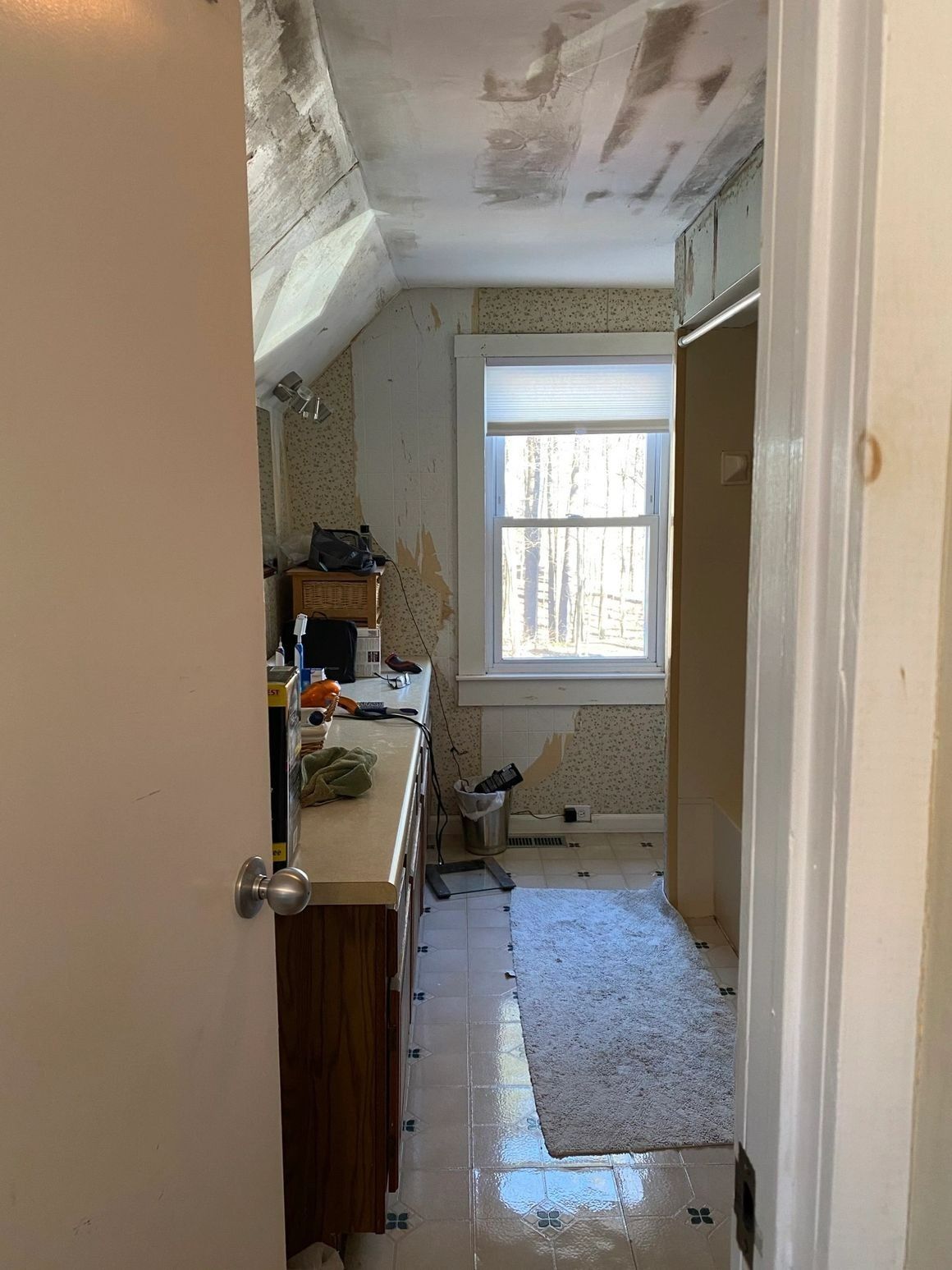 A bathroom with a sink and a window is being remodeled.