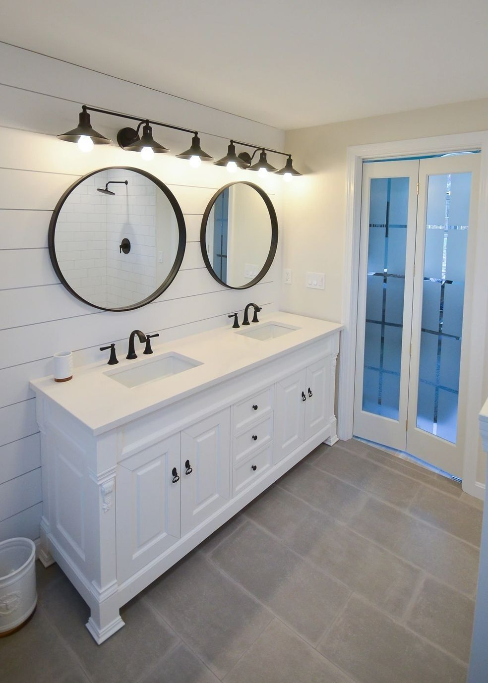 A bathroom with two sinks and two mirrors