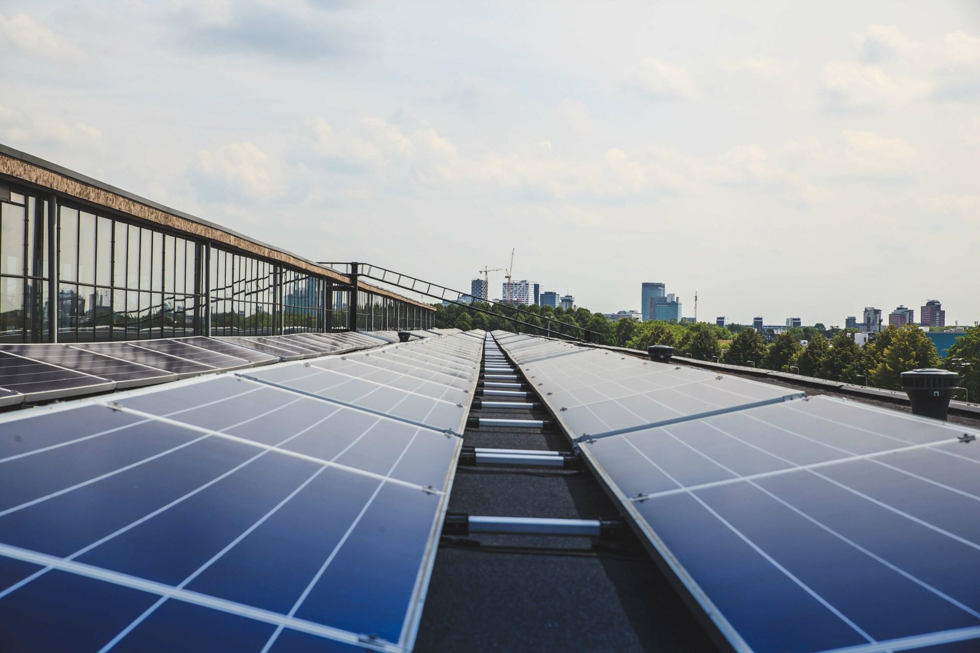 A row of solar panels on the roof of a building.