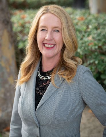 Kaleen Harris, founding partner and president of Harris & McKeown Law Firm, smiling outdoors