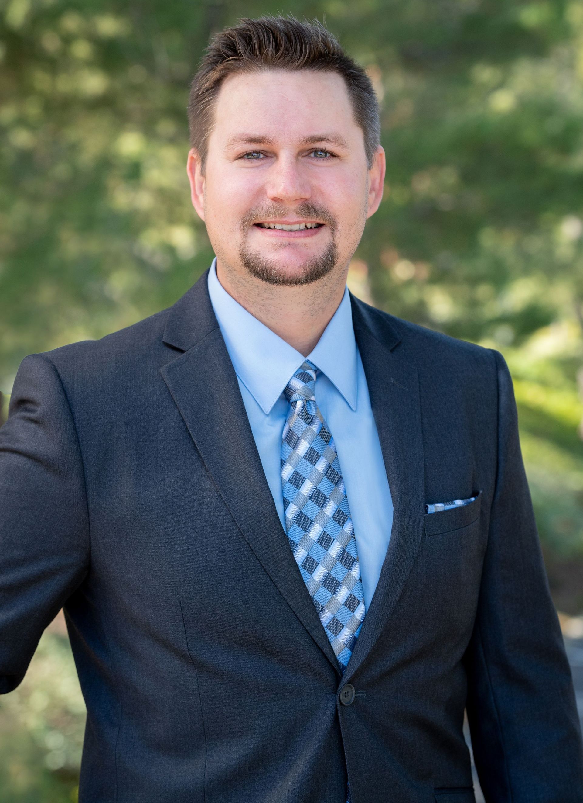 Michael Jakovich, Legal Assistant at Harris & McKeown Law Firm, wearing a suit and tie
