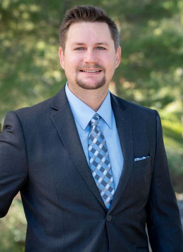 Michael Jakovich, Legal Assistant at Harris & McKeown Law Firm, wearing a suit and tie