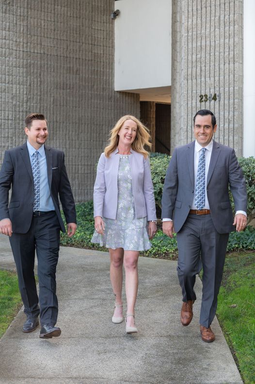 Michael Jakovich, Kalen Harris, and Andrew McKeown standing outdoors in business attire