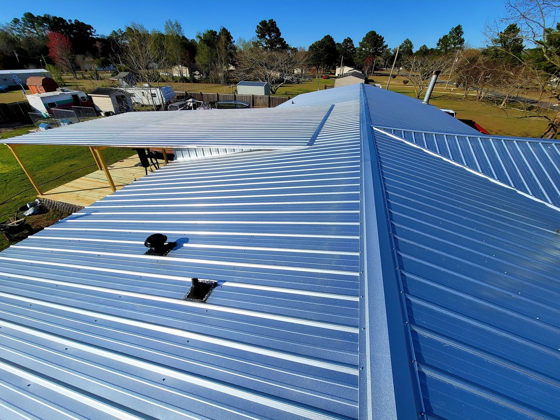 Metal roof on a building, blue sky, outdoors.