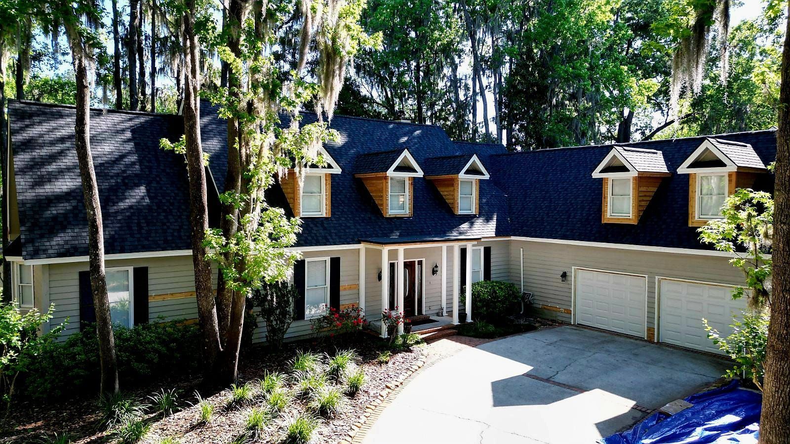 Grey shingle roof on a multi-story building with a balcony.