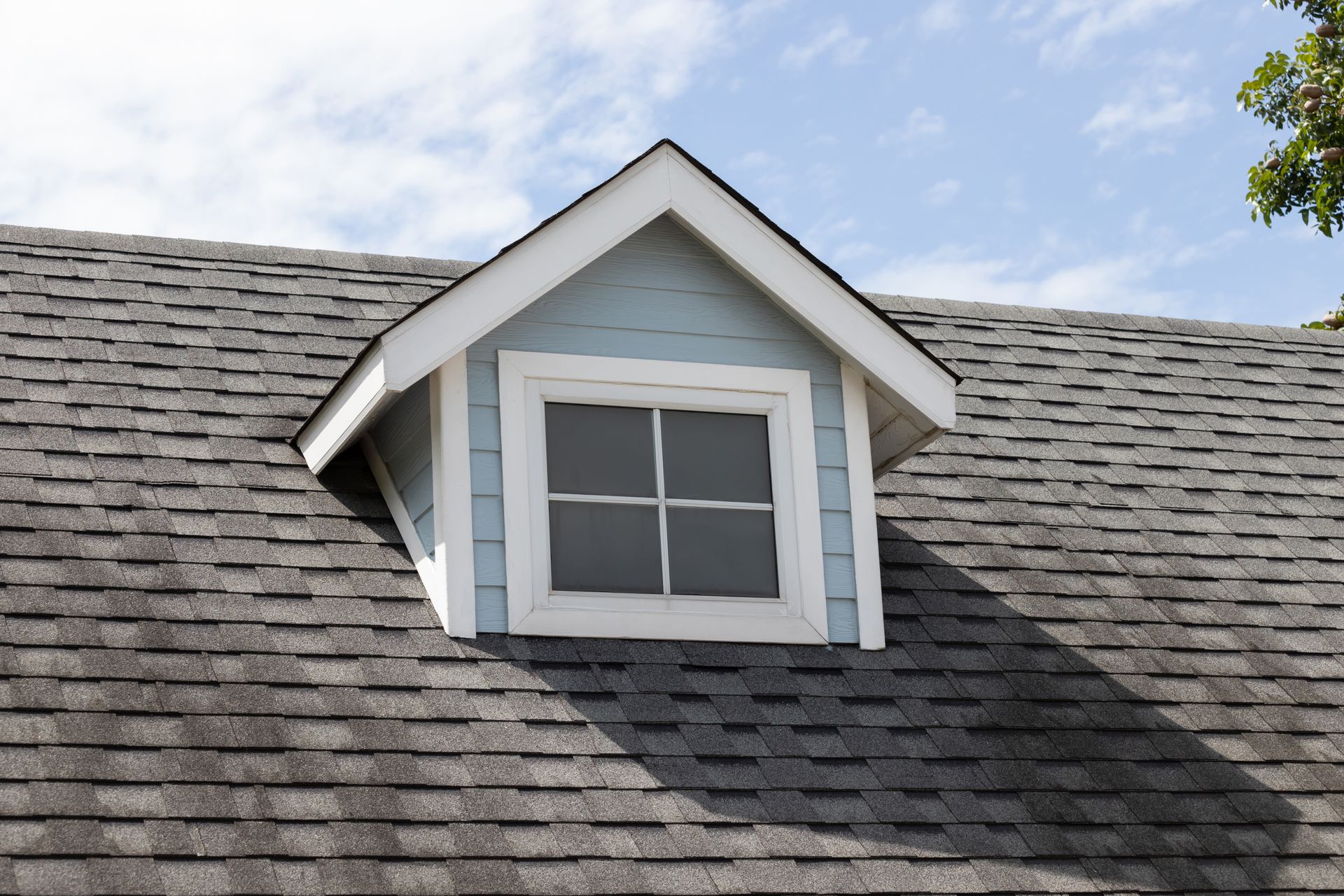 Dark asphalt roof shingles with gable showcasing quality work by a trusted residential roofer.