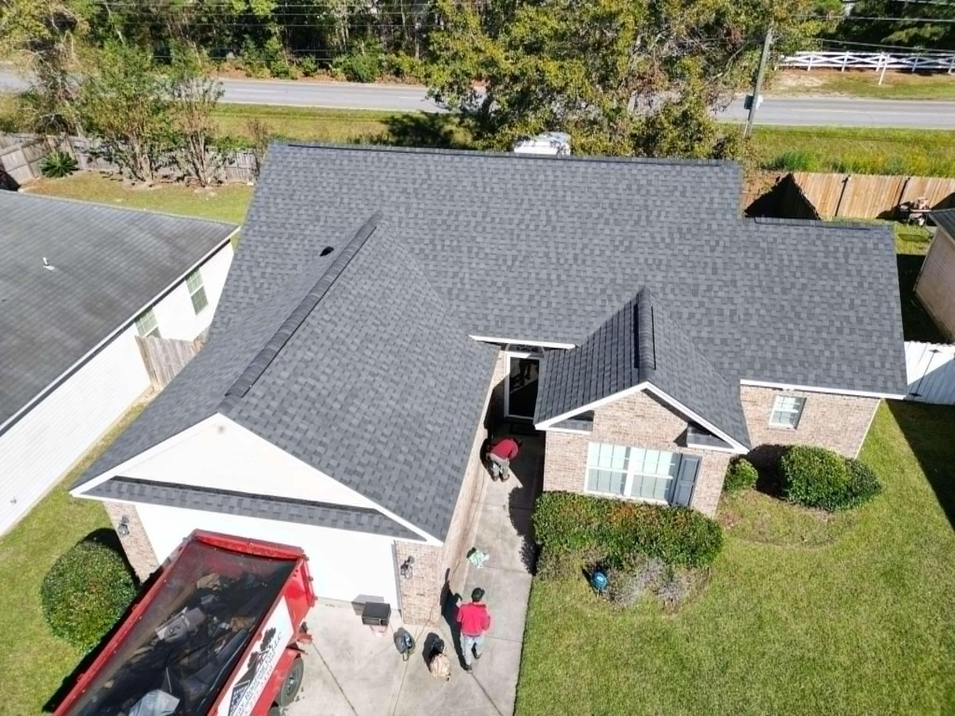 Overhead view of a house with a newly installed gray shingle roof.