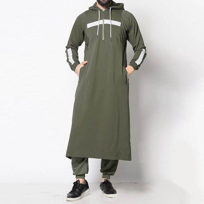 A man is wearing a long green hoodie with white stripes on the sleeves.