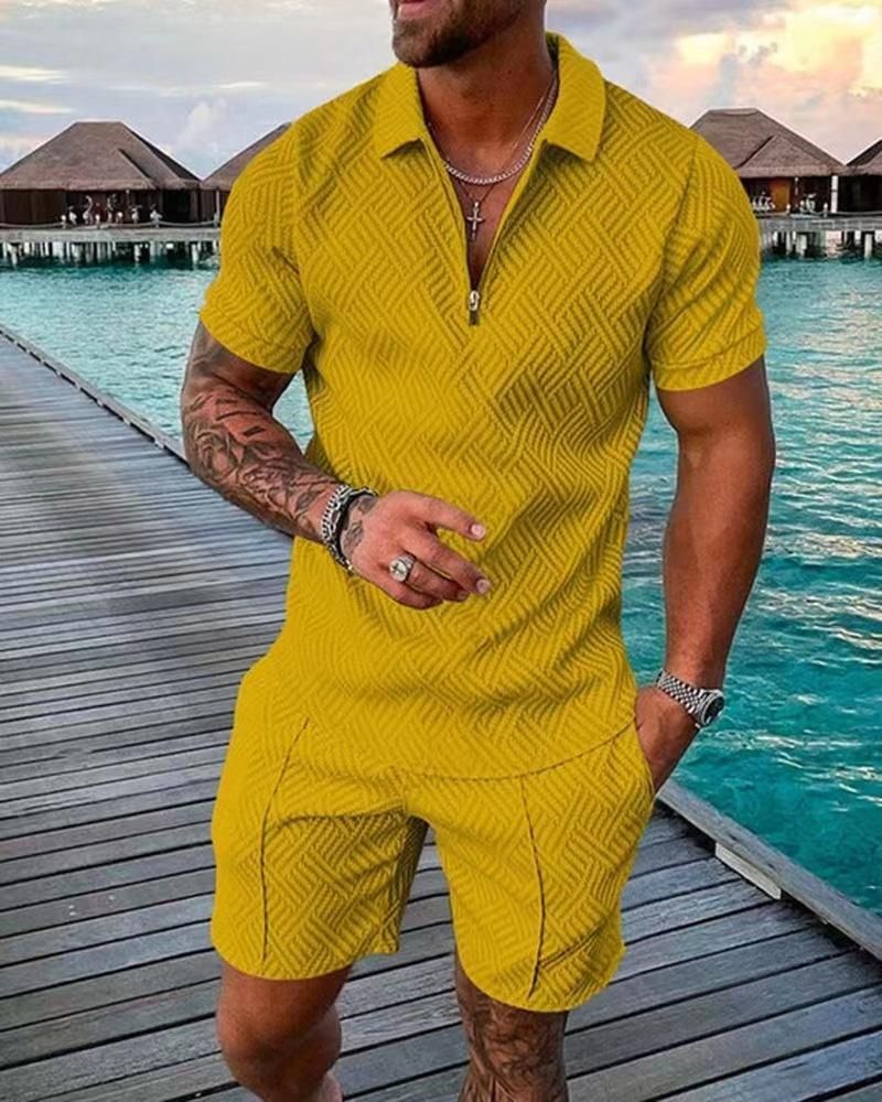 A man in a yellow polo shirt and shorts is standing on a wooden pier.