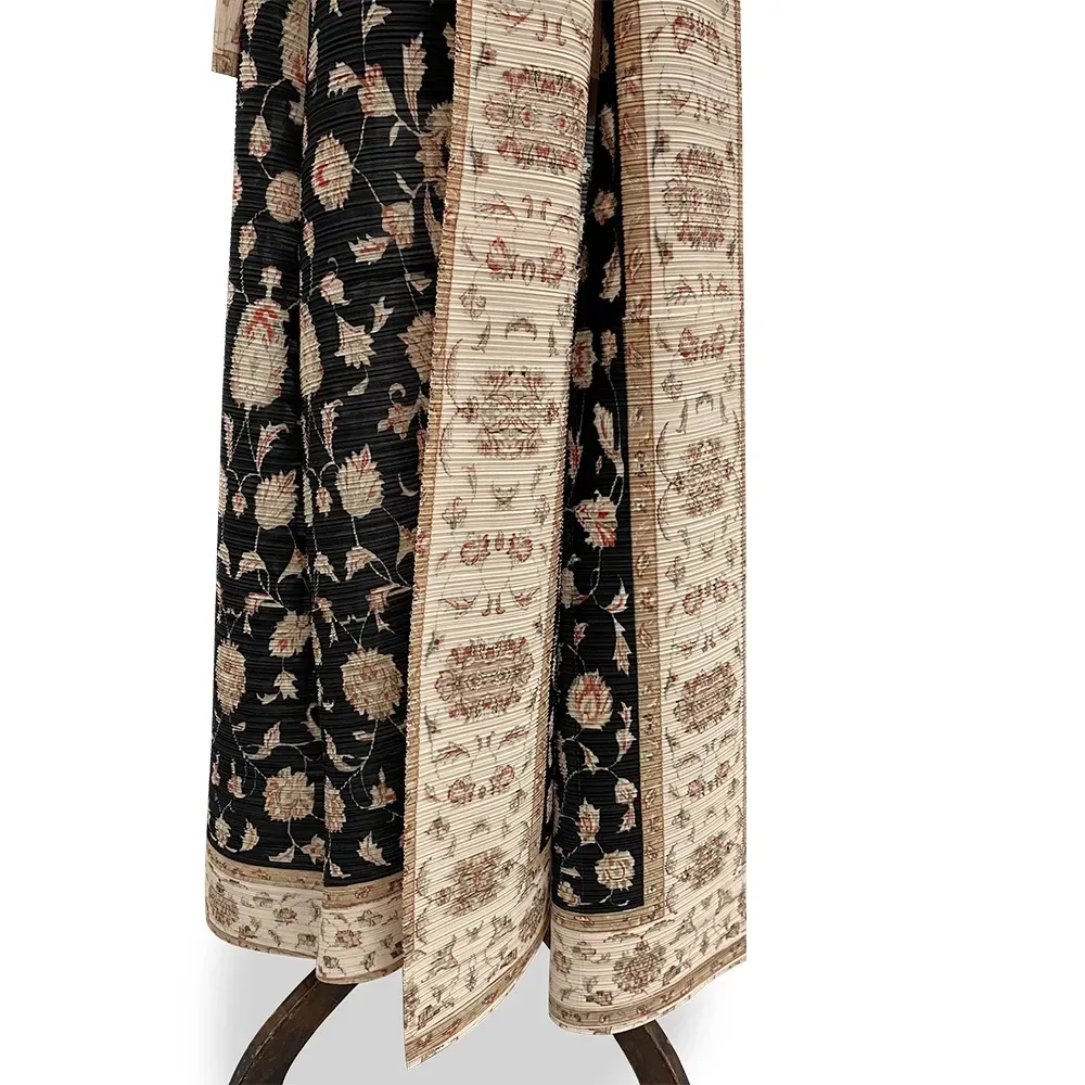 A black and white dress with a floral pattern on it is on a mannequin.