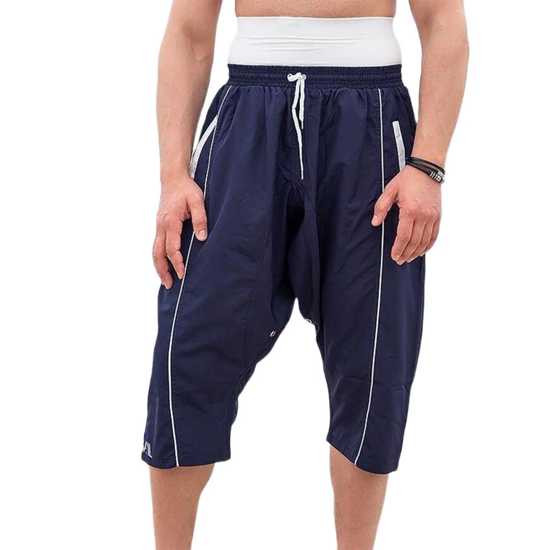 A man wearing tan shorts with a white waistband