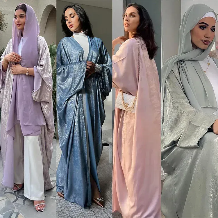 A collage of four pictures of women wearing abayas.