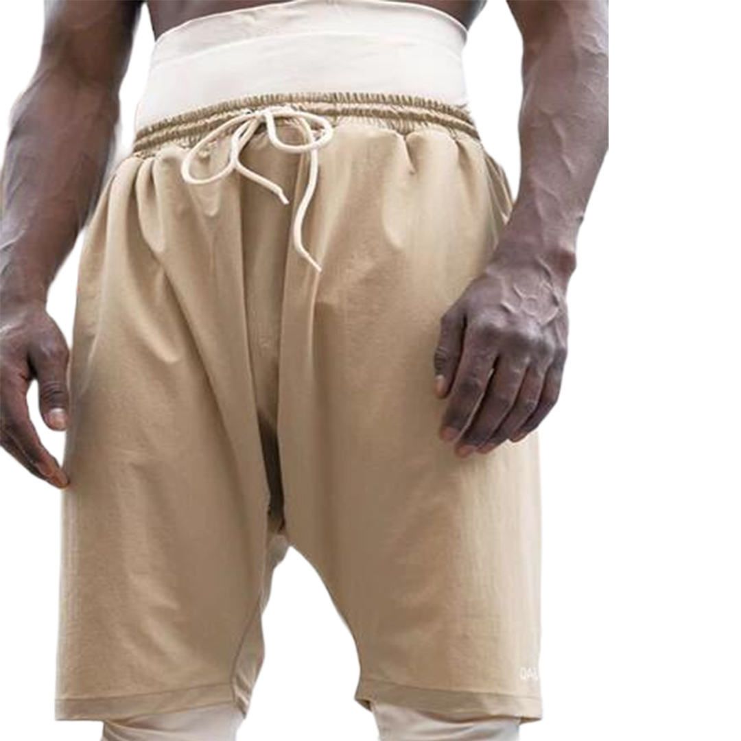A man wearing tan shorts with a white waistband