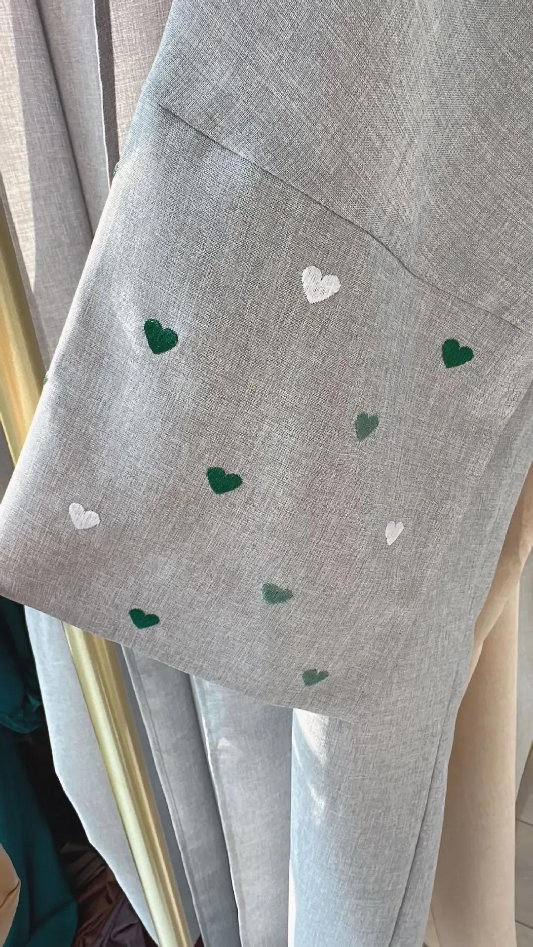 A woman is holding a blue purse on the beach.