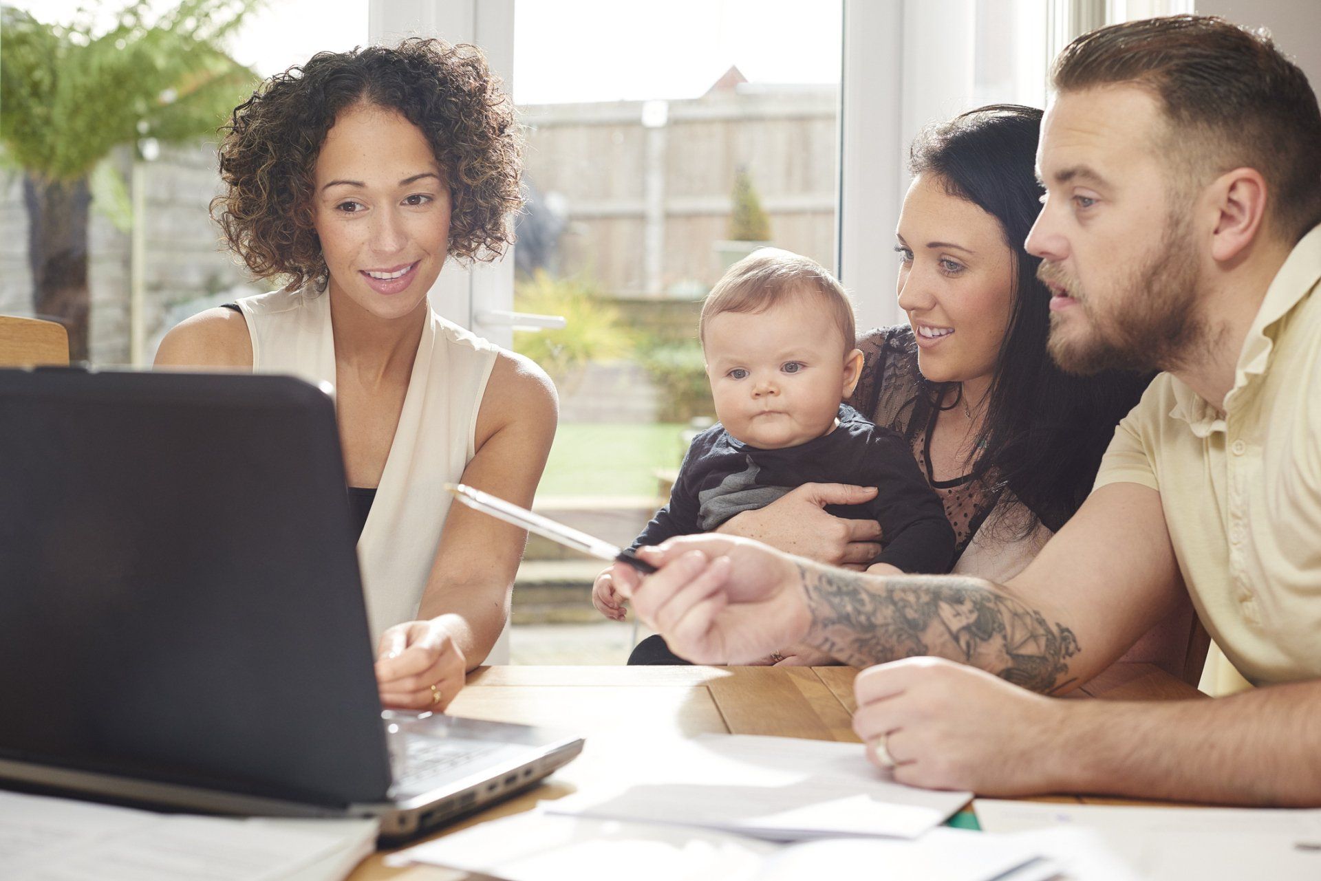 Financial advisor with her clients — Macon, GA — Heart Of Georgia Insurance Brokers