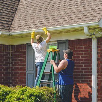 Man and Woman Fixing Gutters — Narberth, PA — Scheinfield Contractors