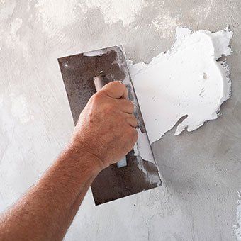 Worker Using Plastering Tool— Narberth, PA — Scheinfield Contractors