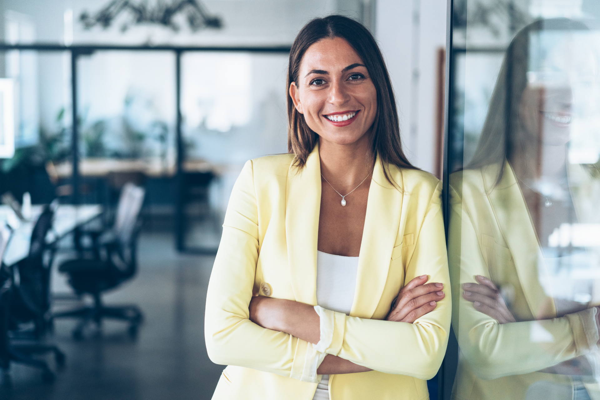 Woman stood in an office next to a window