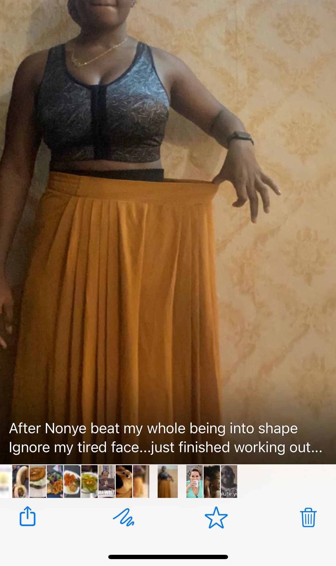 A woman is wearing a crop top and a long skirt.