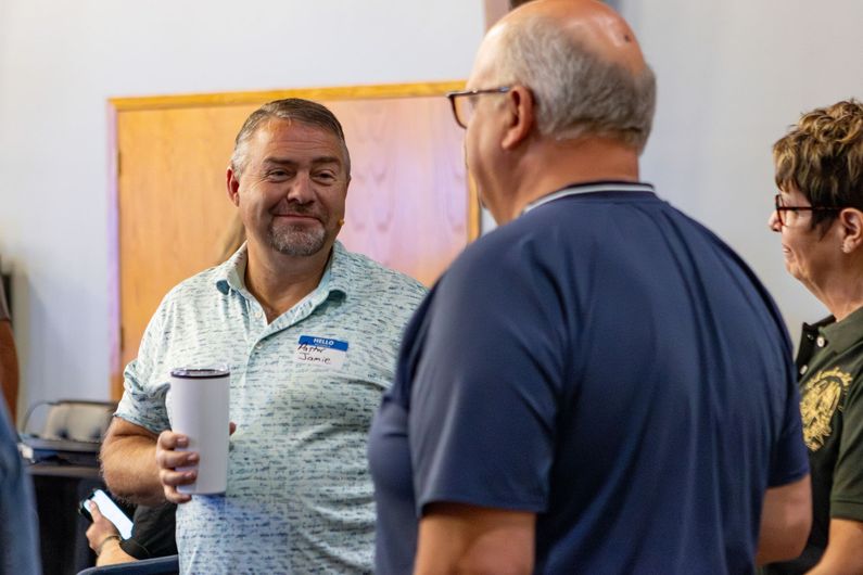 Two women standing next to each other in a hallway