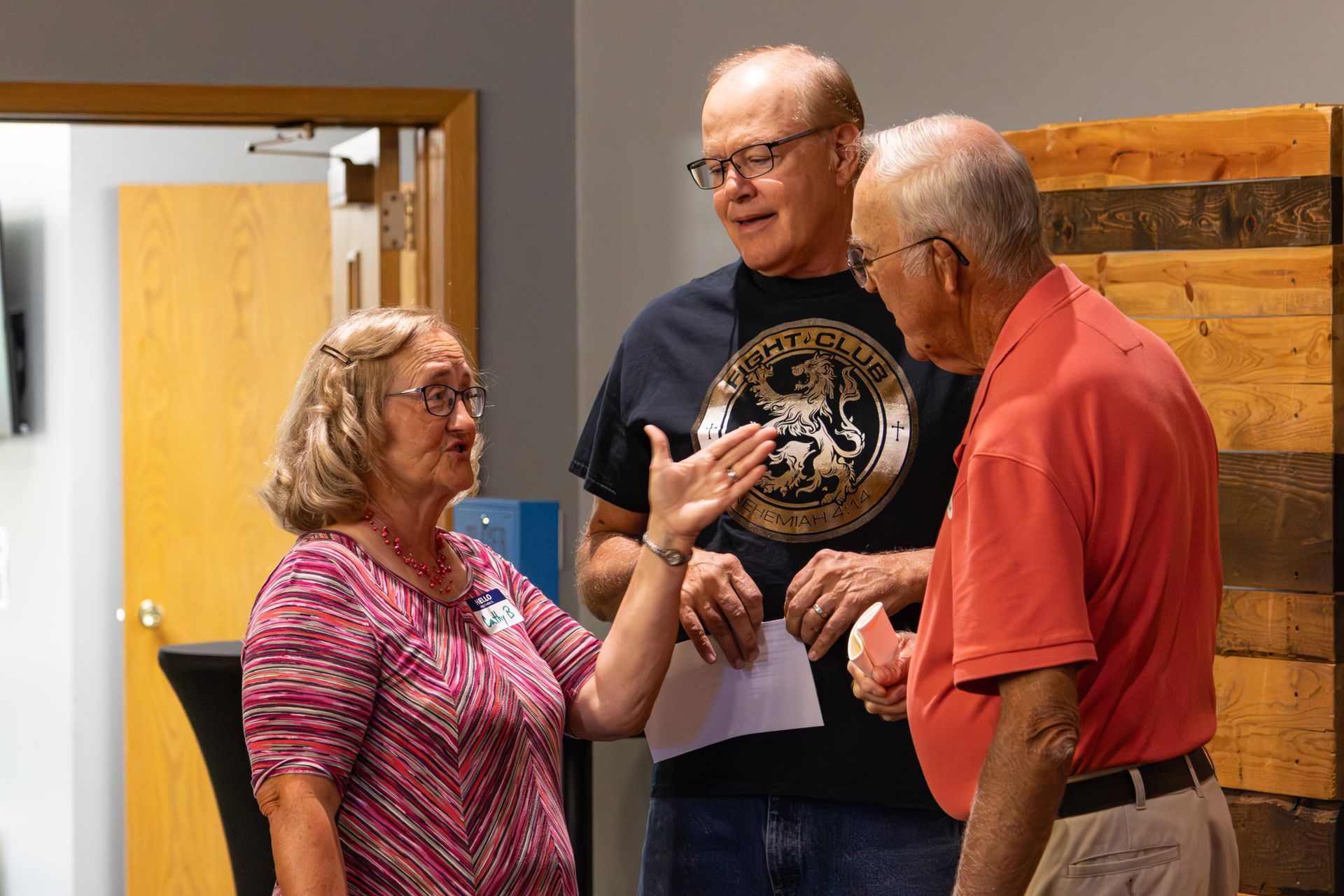 Two girls are standing next to each other on a couch in a living room.
