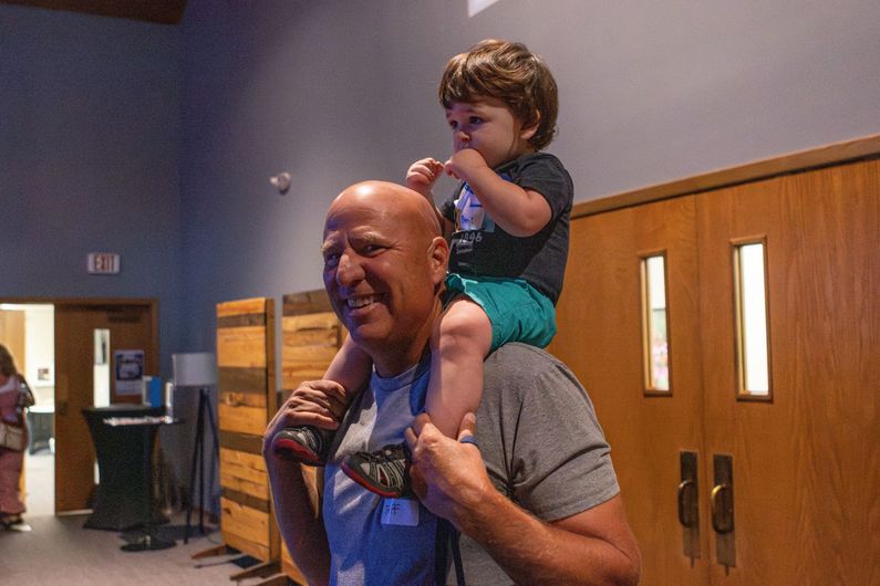 Two women standing next to each other in a hallway