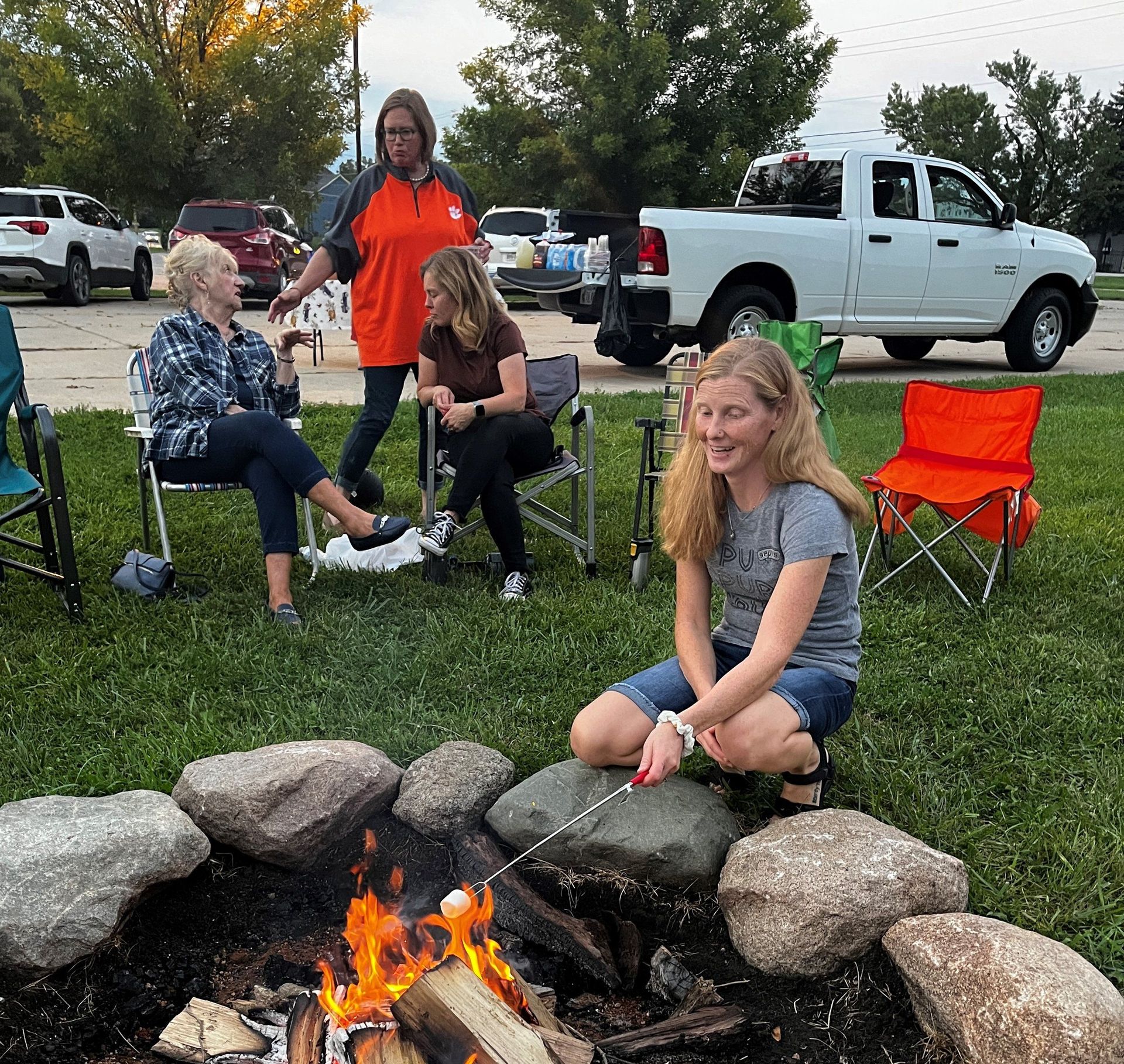 A group of people are sitting around a fire pit.