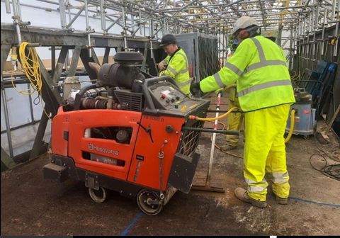 a contractor drilling the wall