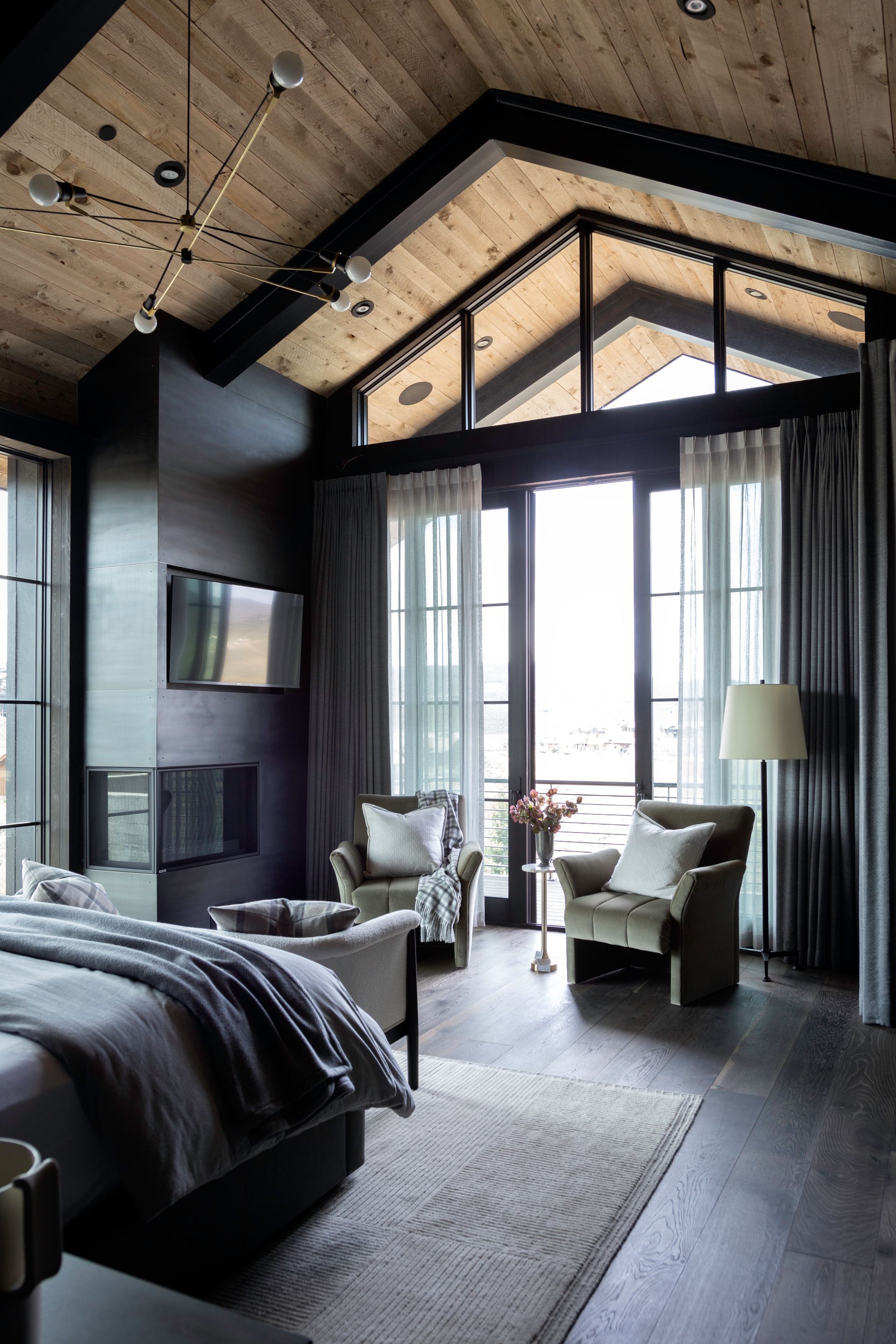 Large window with patterned drapes beside a modern exterior view with palm trees