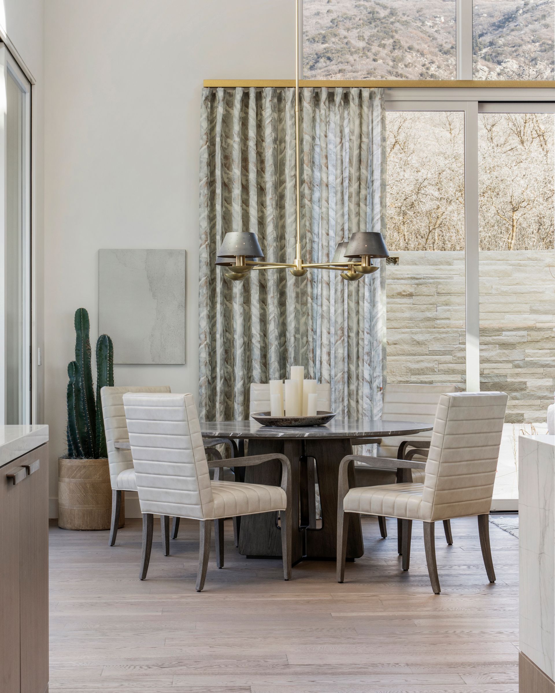 Large window with patterned drapes beside a modern exterior view with palm trees