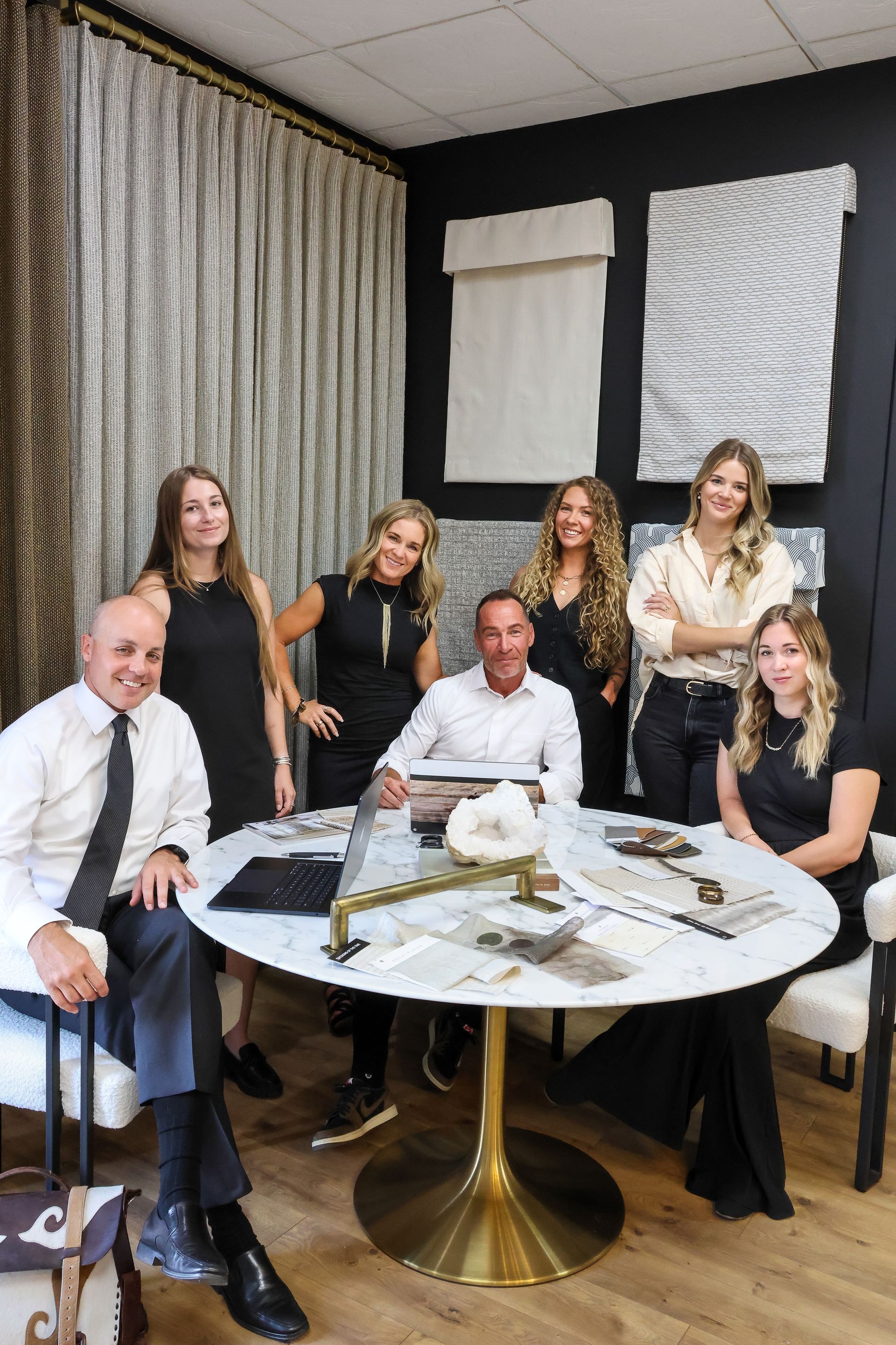 Park City Blind and Design team portrait with three smiling members in front of soft drapery