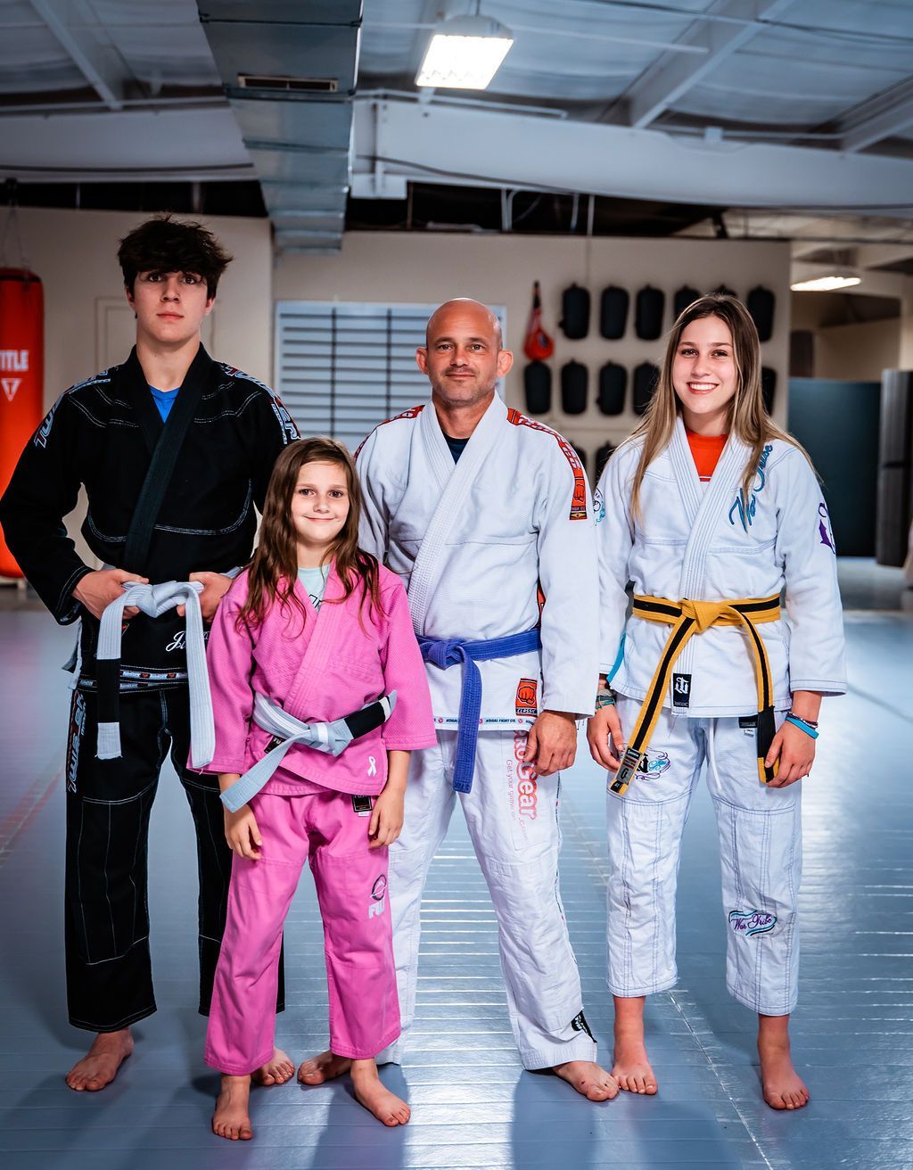 A Group of People in Karate Uniforms Are Posing for A Picture in A Gym | Nixa, MO | Grappling Concepts Nixa
