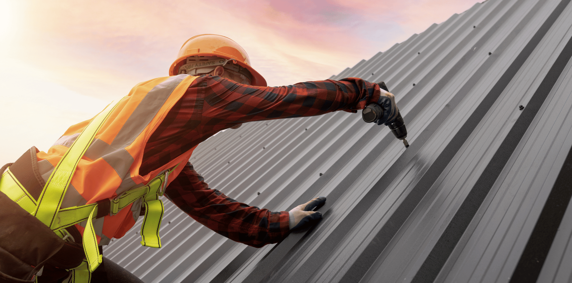 Tradesman fixing a metal roof