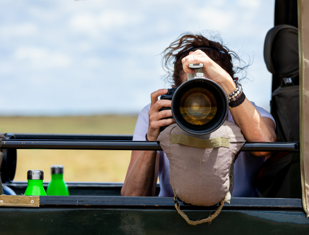 A woman taking a picture with a camera in a vehicle