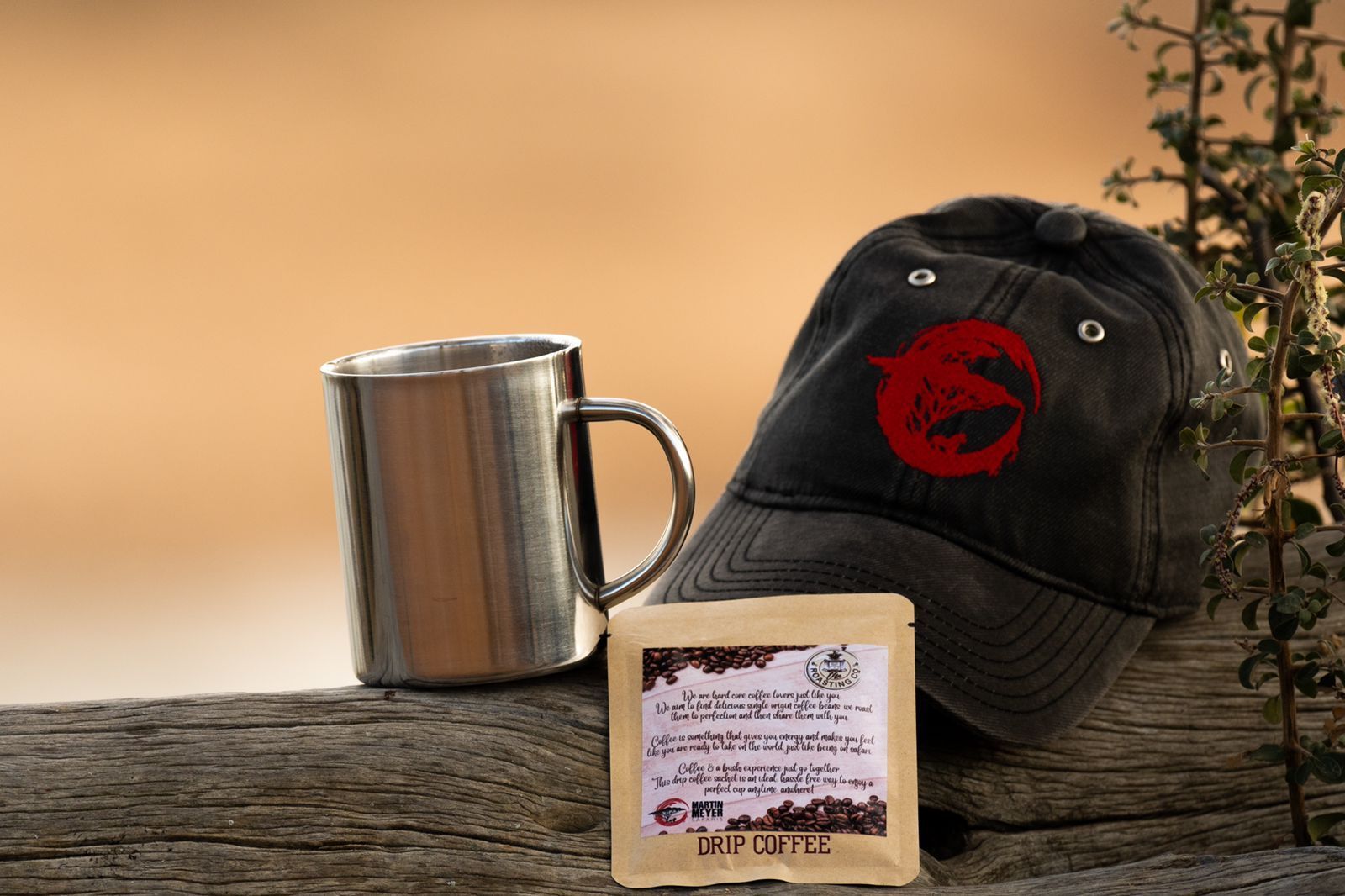 A hat and a mug are sitting on a wooden table.