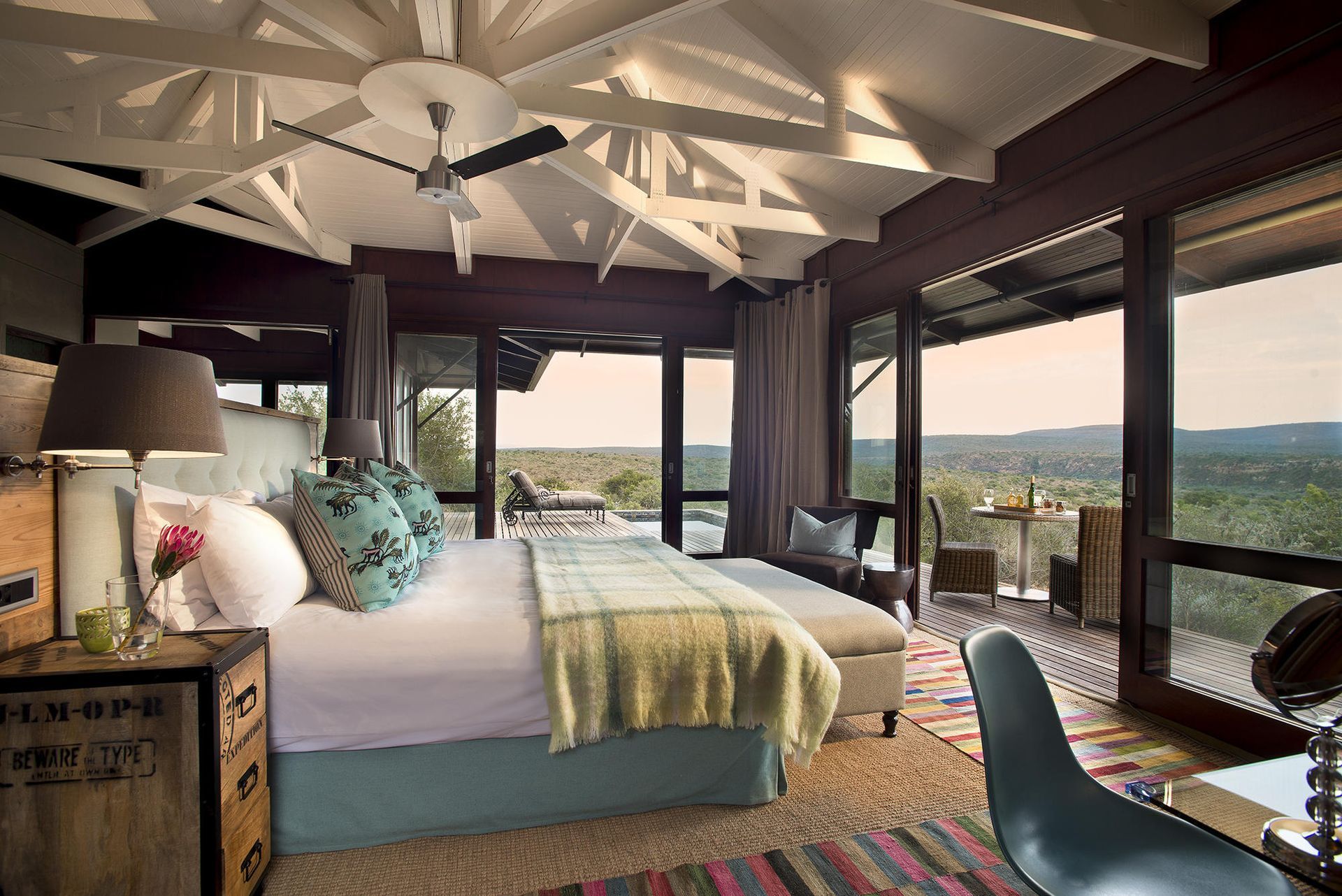 A bedroom with a large bed and lots of windows Malaria Free Safari Destinations