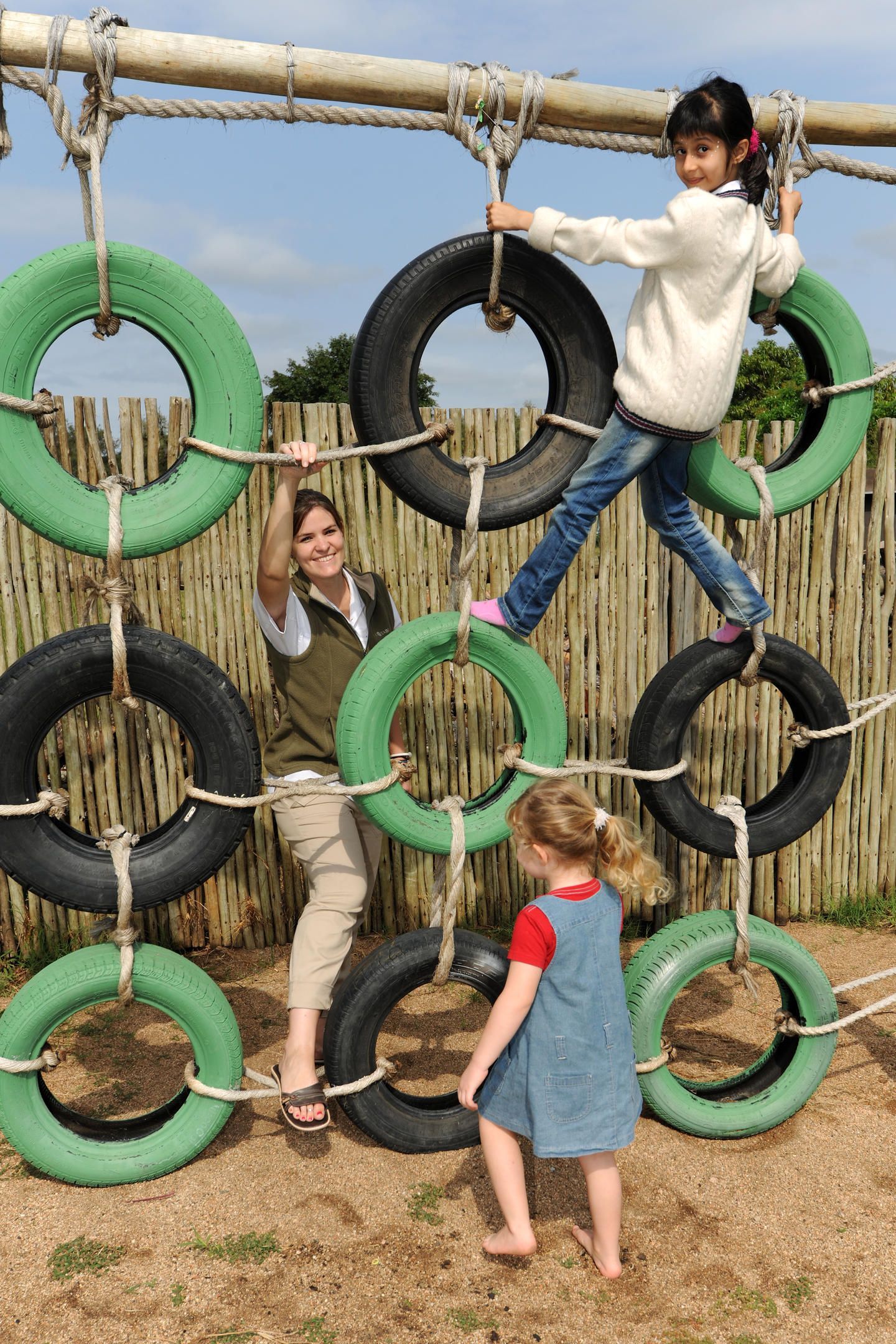A group of children are playing on a playground made out of tires. Family Friendly Safari